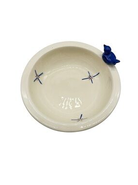 Vintage pottery serving bowl featuring a blue bird figurine Storyteller?